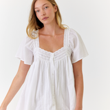 White cotton mini dress worn on a sunny summer morning