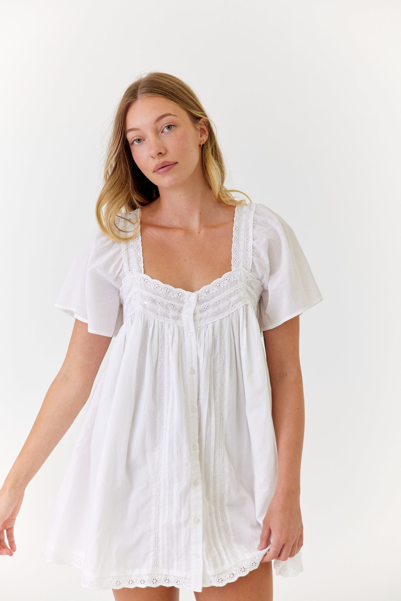 White cotton mini dress worn on a sunny summer morning